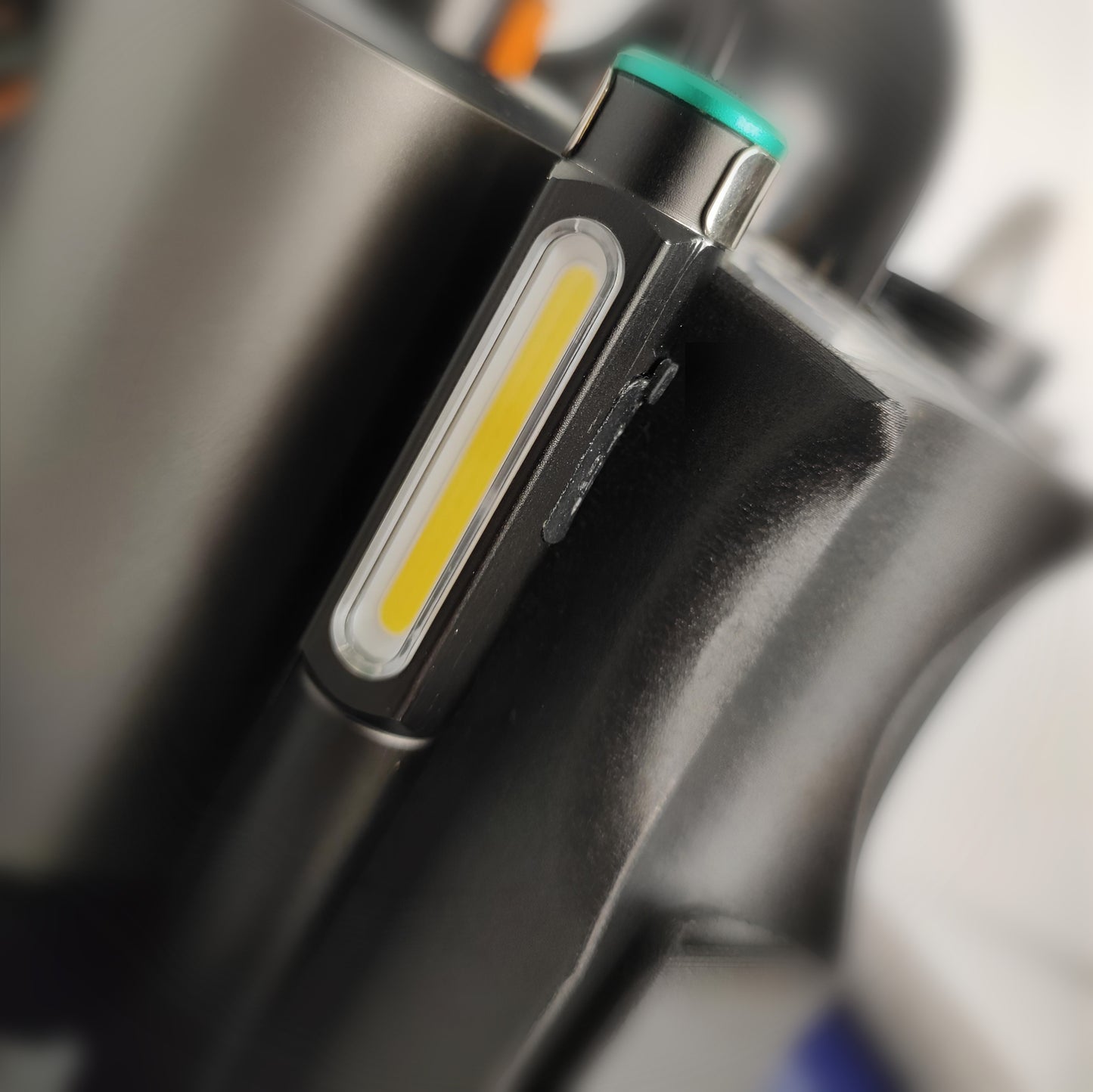 Extreme close-up of Elite Vision torch highlighting fungal and also money on a nail, with the black Onyx extraction drill blurred behind—showcasing podiatry instruments, podiatry equipment for sale, chiropodist equipment for sale, podiatrist nail drill, podiatry tools, and foot care supplies from leading foot care suppliers.